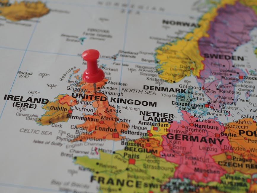 Close-up of a European map highlighting the UK with a red pin, perfect for geography themes.